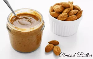the image contains almond butter and a bucket of almonds