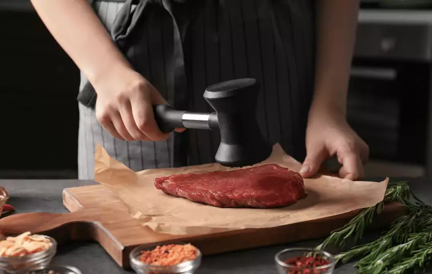 A meat mallet is a tool used to pound or tenderize meat. It is usually made of wood, metal, or plastic and has a long, heavy handle attached to a flat, blunt head. 